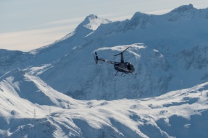 A Helicopter over a snowy mountain